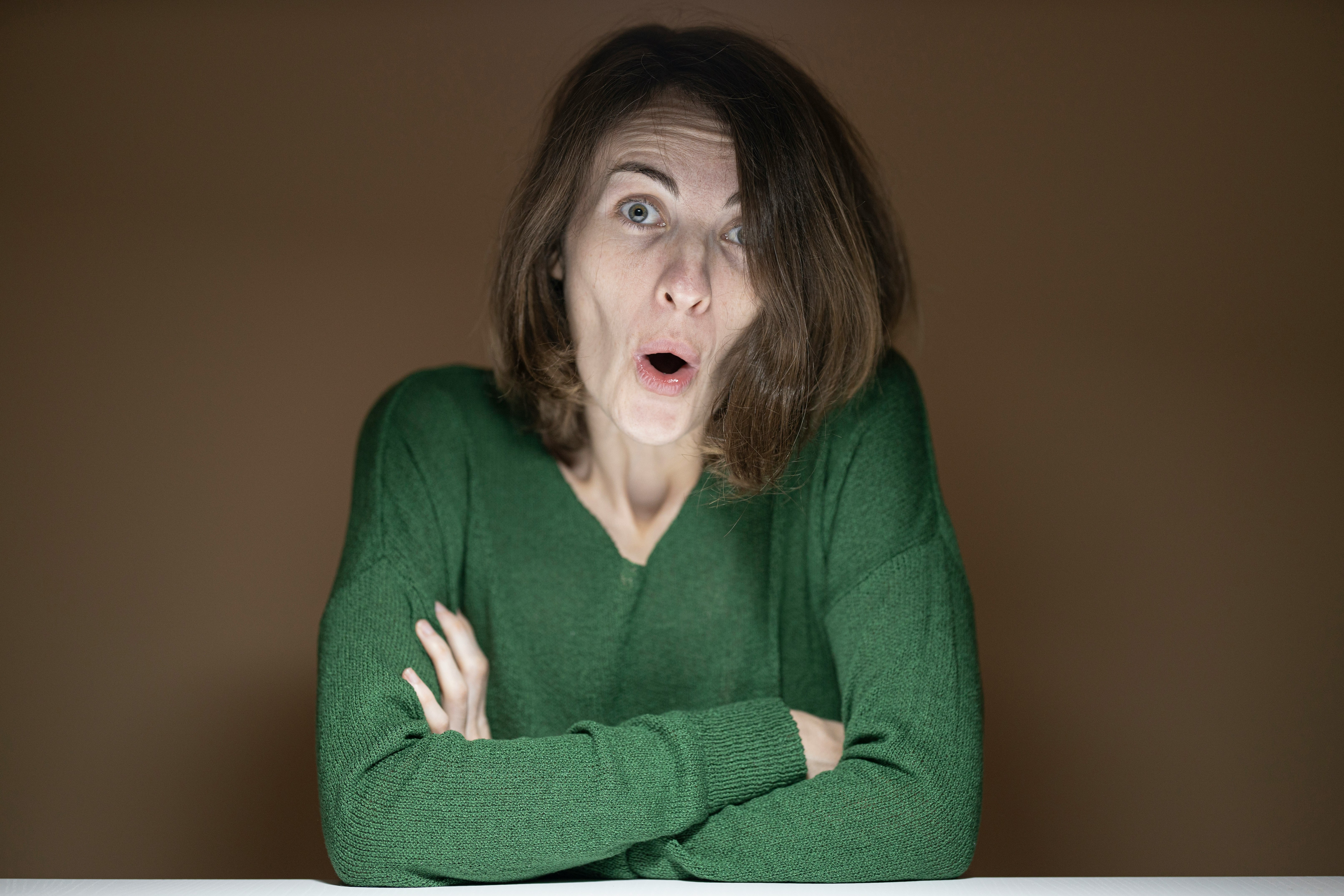 woman in green sweater with pink lipstick